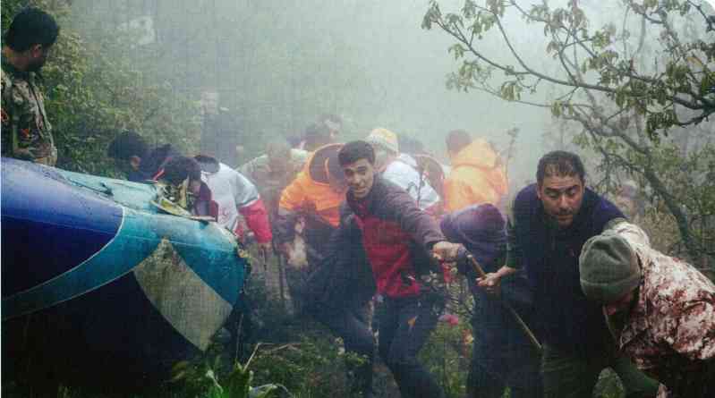 Search and rescue personnel found the wreckage of Bell-212 despite the bad mountain climate. Note that the helicopter is upside down. 